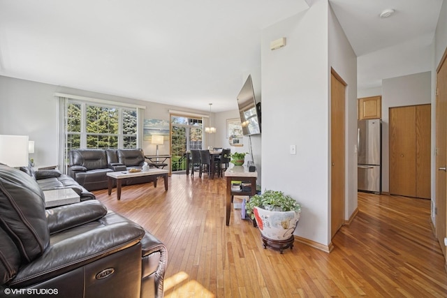 living room featuring baseboards and light wood-type flooring