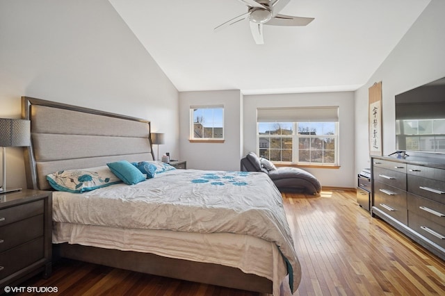 bedroom with a ceiling fan, vaulted ceiling, and hardwood / wood-style flooring