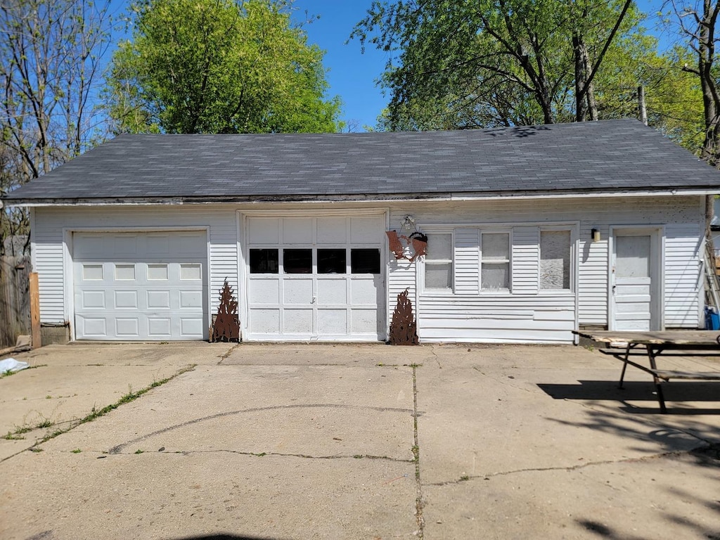 garage featuring concrete driveway