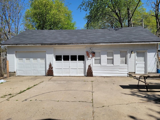 garage featuring concrete driveway