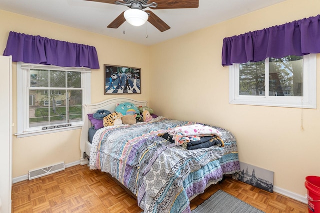 bedroom featuring baseboards, multiple windows, and visible vents