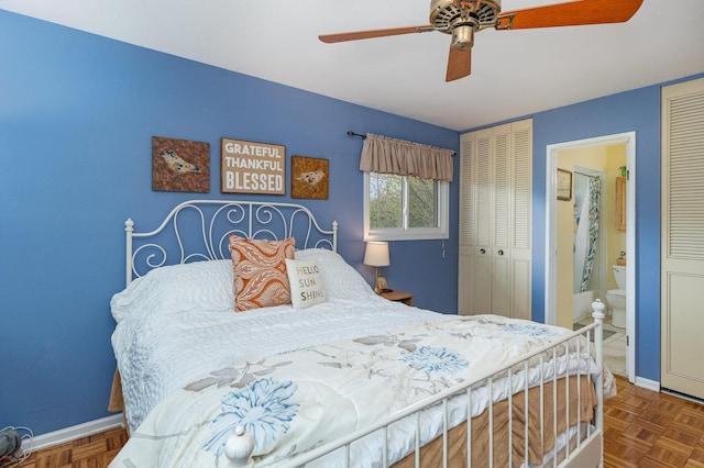 bedroom with connected bathroom, baseboards, and ceiling fan