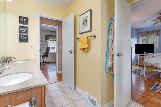 full bathroom with a sink, ceiling fan, connected bathroom, and visible vents