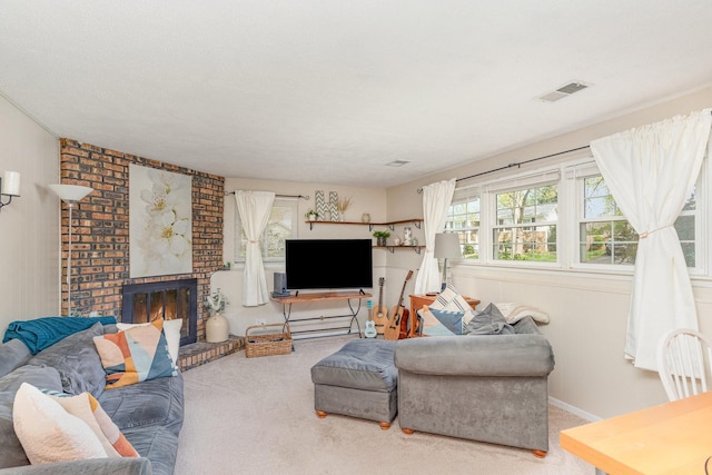 living room featuring a fireplace, carpet, and visible vents