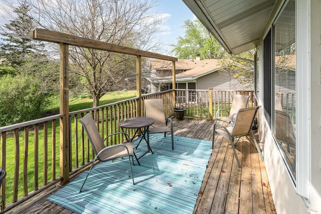 wooden terrace with a lawn