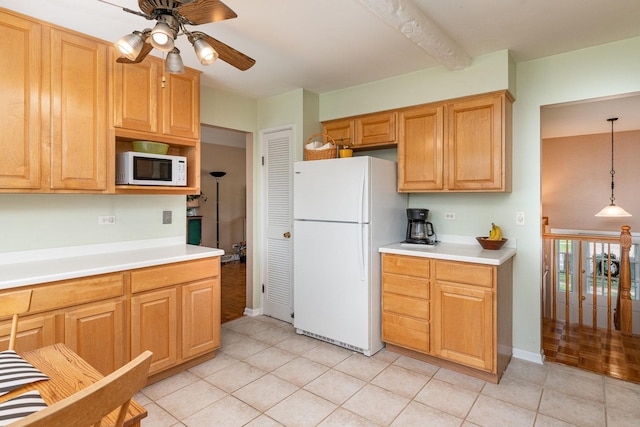 kitchen with light tile patterned floors, light countertops, a ceiling fan, and white appliances