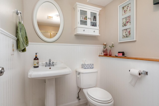 bathroom with wainscoting and toilet