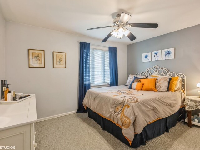 carpeted bedroom with baseboards and a ceiling fan