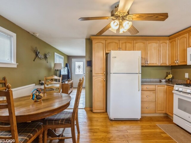 kitchen featuring light wood-style floors, a ceiling fan, and white appliances