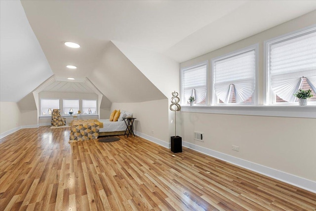 interior space with recessed lighting, light wood-style floors, baseboards, visible vents, and lofted ceiling