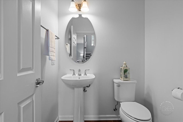 half bathroom with a sink and toilet