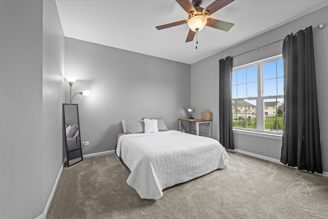 carpeted bedroom with baseboards and a ceiling fan