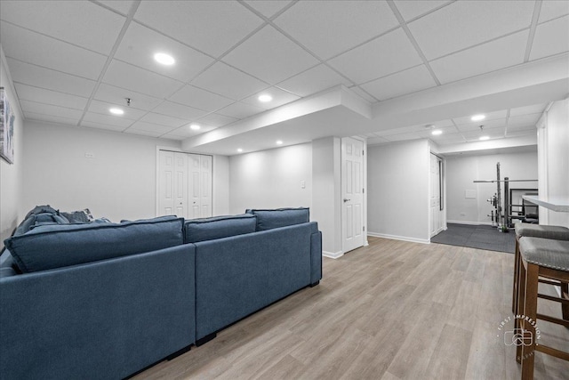 living area featuring recessed lighting, a drop ceiling, and wood finished floors