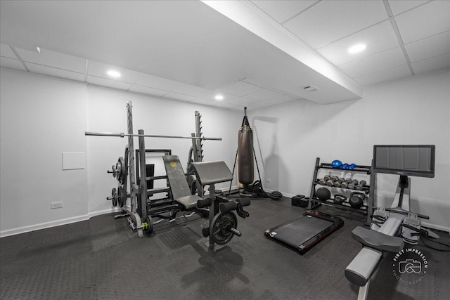 exercise area featuring baseboards, visible vents, recessed lighting, and a paneled ceiling