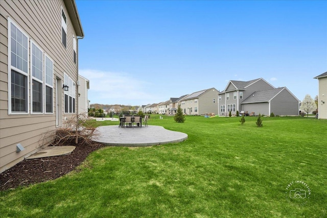 view of yard featuring a patio and a residential view