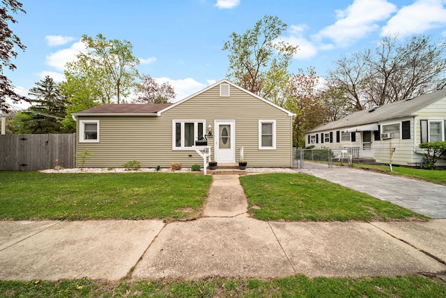 bungalow featuring a gate and driveway