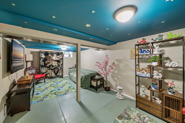 below grade area with tile patterned flooring and baseboards
