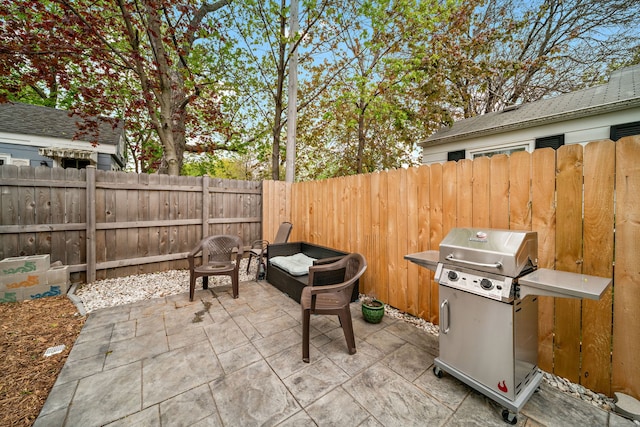 view of patio with grilling area and a fenced backyard