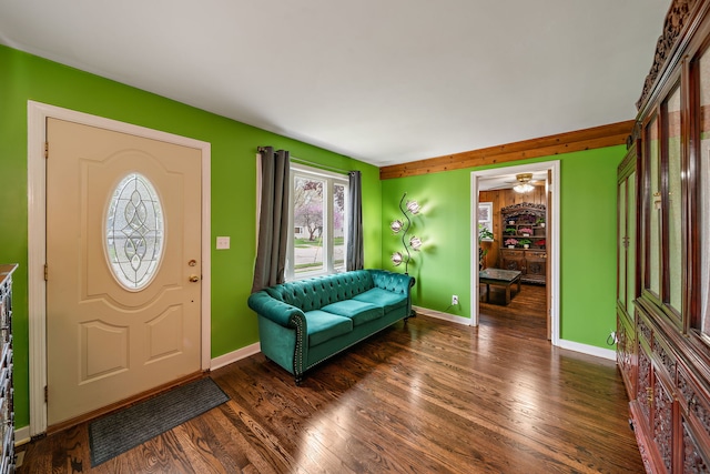 foyer entrance featuring wood finished floors, baseboards, and a ceiling fan