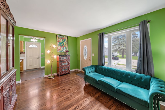 living room featuring dark wood-type flooring and baseboards