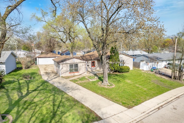 view of front of property with a residential view, a front yard, a detached garage, and fence
