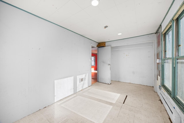 unfurnished room with tile patterned floors, recessed lighting, and a baseboard heating unit