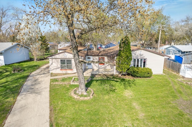 view of front of property with fence, a residential view, and a front yard