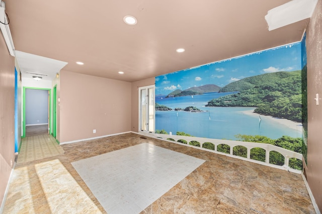 interior space featuring baseboards, recessed lighting, and a water view