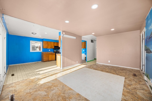 interior space featuring recessed lighting and baseboards