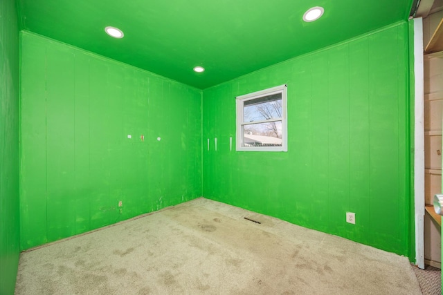 empty room with recessed lighting and carpet