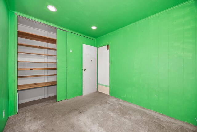unfurnished bedroom featuring recessed lighting, a closet, and carpet floors