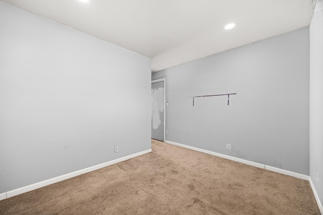 carpeted spare room featuring baseboards and recessed lighting