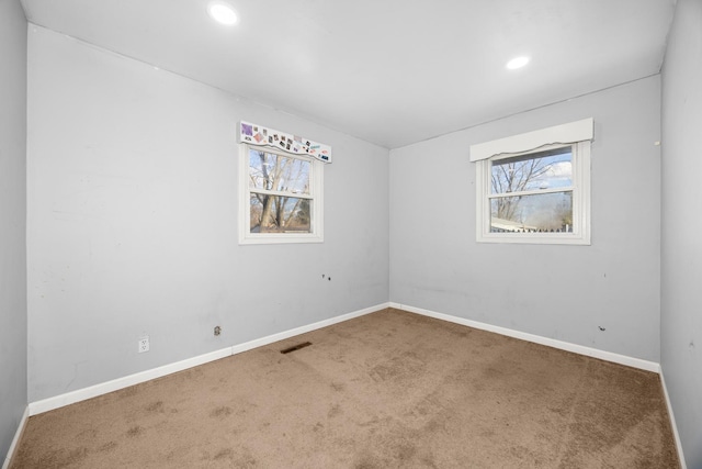 spare room featuring baseboards, recessed lighting, and carpet floors