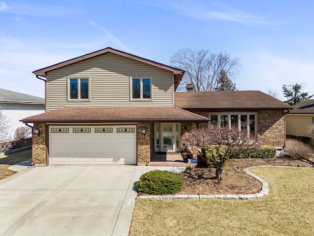 view of front of house with concrete driveway, a garage, a front lawn, and brick siding