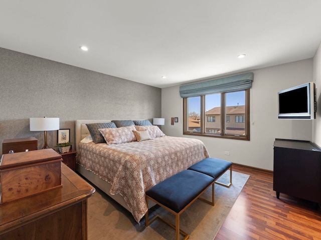 bedroom with wood finished floors, recessed lighting, and baseboards