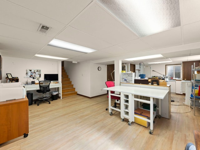 home office featuring visible vents, light wood-style floors, and a paneled ceiling