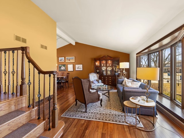 living area featuring visible vents, wood finished floors, and a healthy amount of sunlight