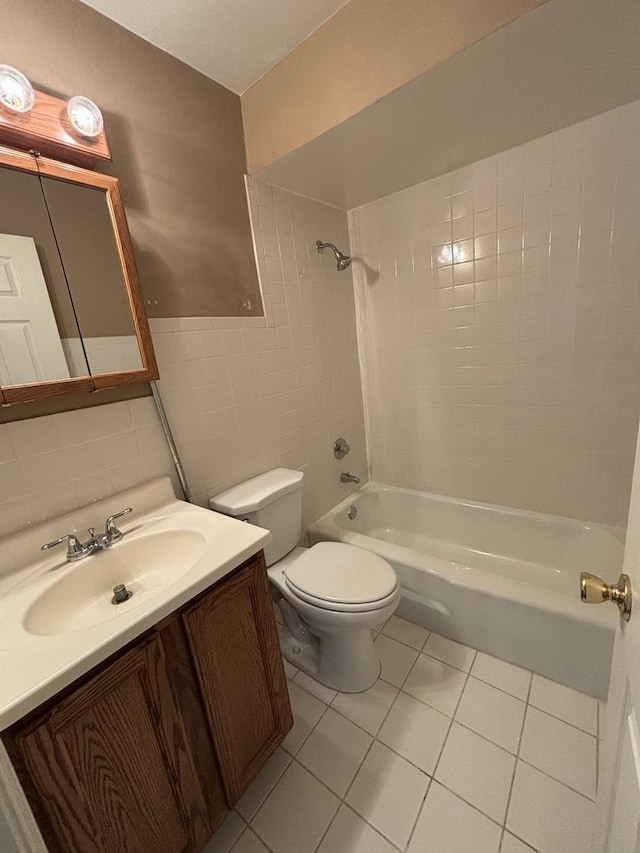 full bath featuring tile walls, shower / bathtub combination, toilet, tile patterned floors, and vanity