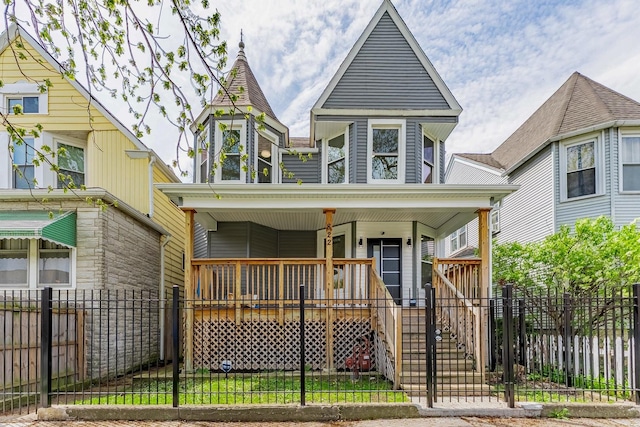 822 N Lockwood Ave, Chicago, IL 60651 - victorian home featuring covered porch, stairway, and a fenced front yard