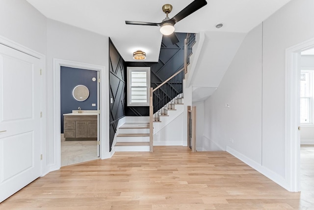 822 N Lockwood Ave, Chicago, IL 60651 - foyer entrance with stairs, a ceiling fan, baseboards, and light wood-style floors