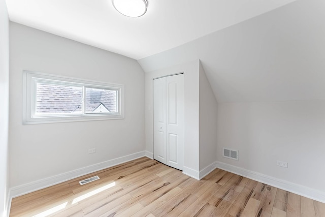 822 N Lockwood Ave, Chicago, IL 60651 - additional living space with visible vents, lofted ceiling, and light wood-style floors