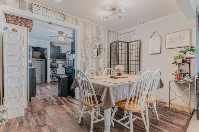 dining space featuring ceiling fan, crown molding, and dark wood-type flooring