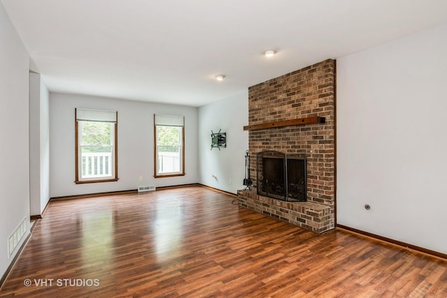 41W058 Colson Dr, Saint Charles, IL 60175 - unfurnished living room featuring wood finished floors, a brick fireplace, and baseboards