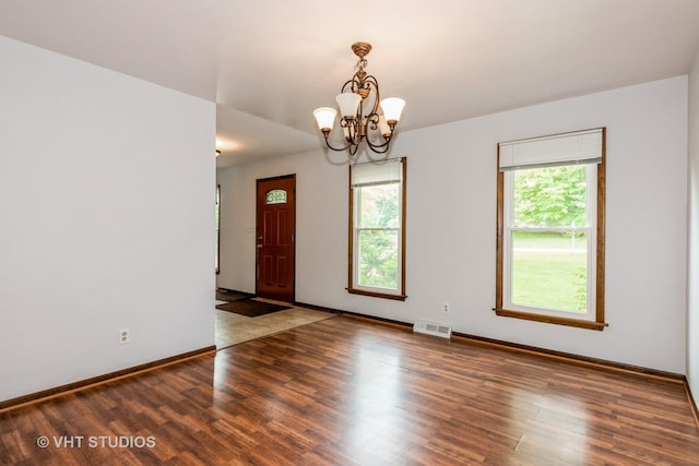41W058 Colson Dr, Saint Charles, IL 60175 - unfurnished room featuring wood finished floors, a chandelier, and baseboards