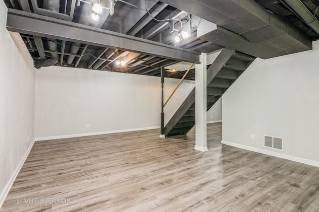 41W058 Colson Dr, Saint Charles, IL 60175 - finished basement featuring stairway, baseboards, and wood finished floors