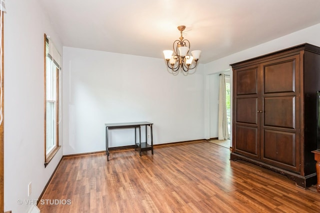 41W058 Colson Dr, Saint Charles, IL 60175 - unfurnished room with a chandelier, wood finished floors, and baseboards