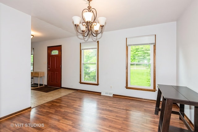 41W058 Colson Dr, Saint Charles, IL 60175 - unfurnished dining area with wood finished floors, a chandelier, and baseboards
