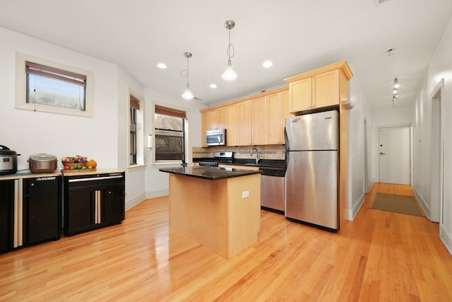 7633 N Greenview Ave Unit 3W, Chicago, IL 60626 - kitchen with stainless steel appliances, light wood-style floors, light brown cabinets, a center island, and backsplash