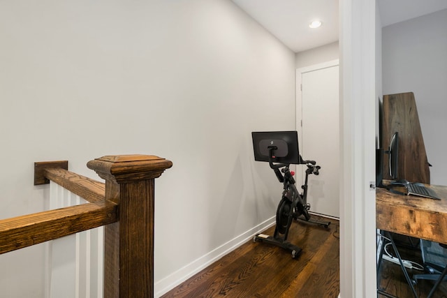 exercise area featuring dark wood finished floors, baseboards, and recessed lighting
