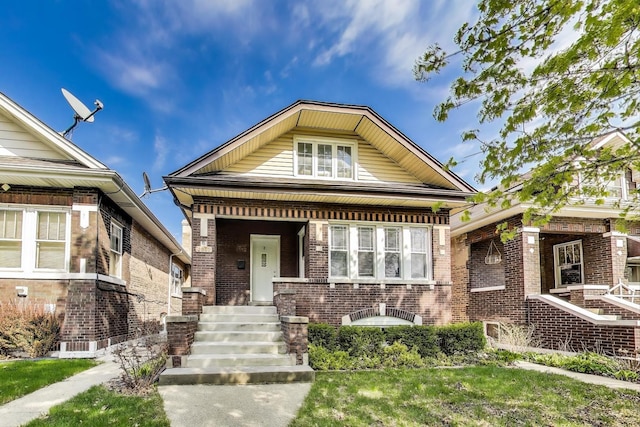 bungalow-style home featuring brick siding
